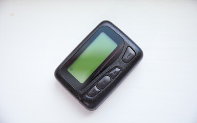 pager beeper lies on a desk, symbolizing instant communication and connection, bridging distances and enabling efficient messaging in the digital age