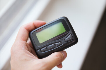 pager beeper lies on a desk, symbolizing instant communication and connection, bridging distances and enabling efficient messaging in the digital age