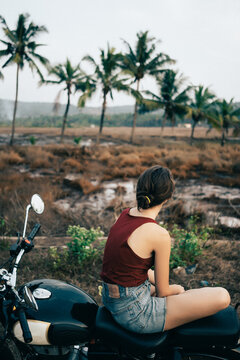 Woman sitting on motorcycle in the jungles of India 