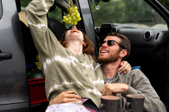 Portrait of cute couple camping in nature next to camper van