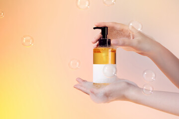 Woman using bottle of antibacterial sanitizer soap.