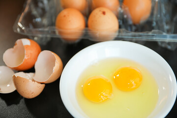 Whole eggs represent vitality and potential, cracked eggs symbolize vulnerability, while yolk represents nourishment. Contextualized against health concerns and rising inflation