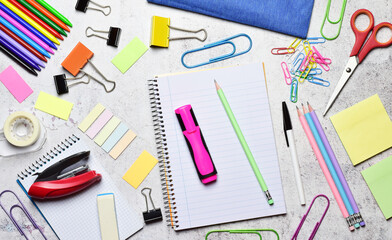 School supplies on light colored stone background, back to school.