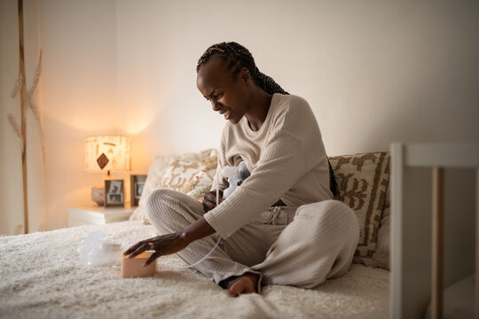 Black woman feeling pain from breast pump