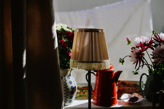 A Vintage Lamp And Teapot By The Window