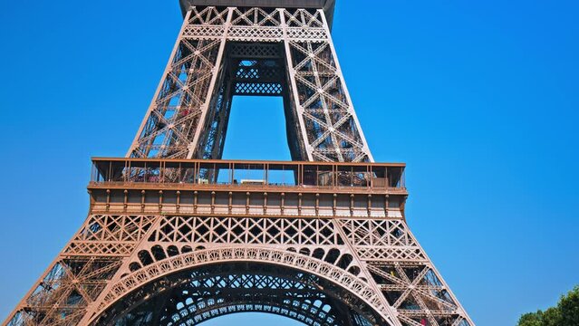 View of the Tower's detailed wrought-iron structure as the camera moves from the base of the tower to the observation deck at the top. Historical landmark of the World famous symbol of Paris, France. 