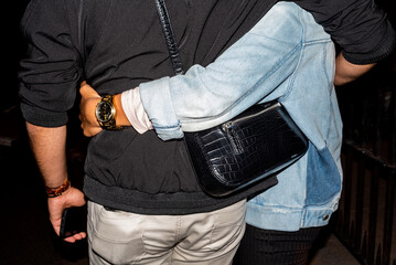 Flash on a couple walking in a hug  