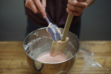 Girl holding mixing spatulas