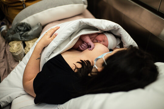 Mother with new born baby on her breast 