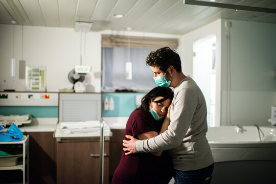 Husband supporting wife during childbirth in the hospital