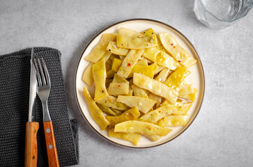 Cooked Yellow Beans, Long Beans in a Plate over Light Grey Background, Tasty Vegetarian Meal