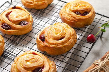 Freshly Baked Puff Pastry with Cherry on Bright Grey Background