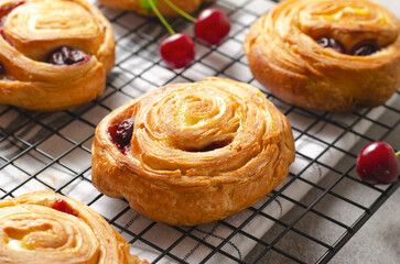 Freshly Baked Puff Pastry with Cherry on Bright Grey Background