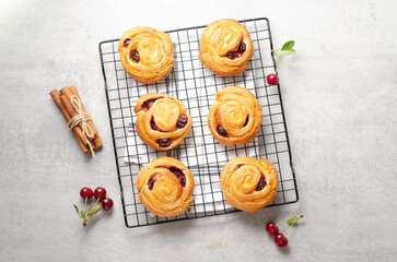 Freshly Baked Puff Pastry with Cherry on Bright Grey Background
