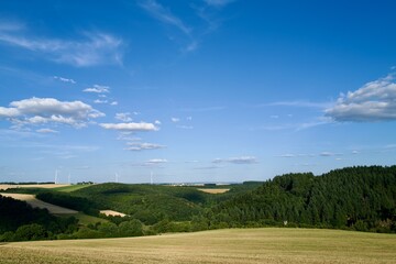 Fototapeta na wymiar landscape with blue sky, clouds and wind generators