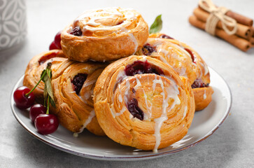 Freshly Baked Puff Pastry with Cherry and Sweet Glaze on Bright Grey Background