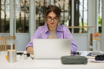 Focused woman using netbook at home office