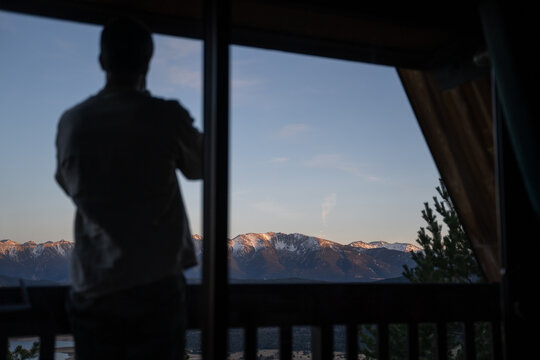 Man by window at cabin