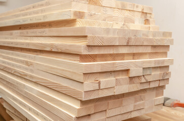 Sawn wooden boards stacked in a production workshop. Carpenter.
