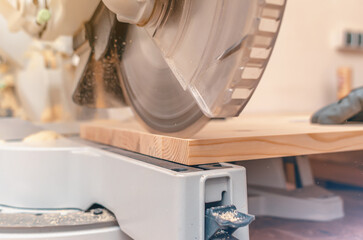Cutting process. Modern circular machine for cutting wooden boards. Wood dust.