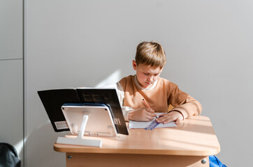 back to school : boy  in a classroom sitting at a desk