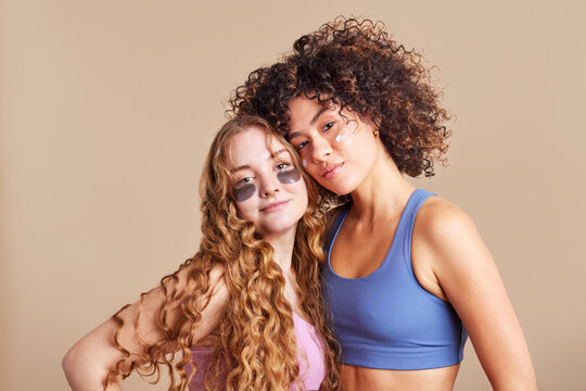 Happy diverse female models with eye patches in studio