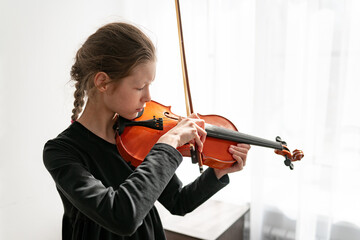 girl playing the violin in the classroom