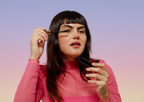 Woman applying eyelashes mascara