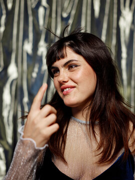 Woman amused with her blowing bangs at night club