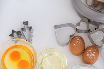 Table with bowl of mixing flour and baking ingredients.