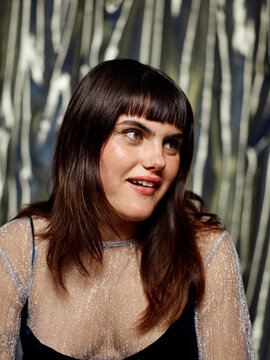 Woman reacting with fun expression at party conversation