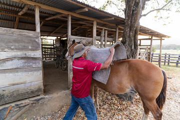 Rider saddling up his horse