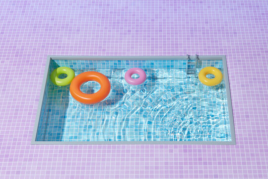 Inflatable rings in pool against pink tiles background.