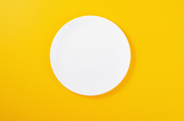 Empty Plate on Yellow Background, Top View