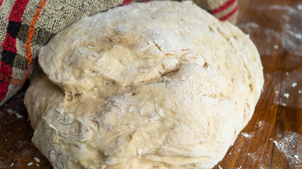 Dough. Dough on a wooden table. A pile of dough