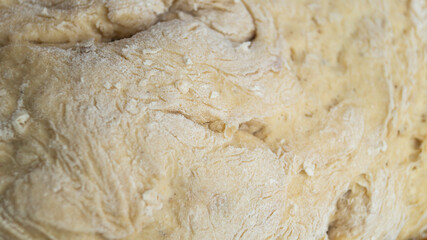 Naklejka na ściany i meble Dough. Dough on a wooden table. A pile of dough