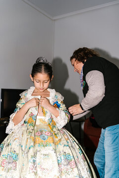 Woman preparing girl for Las Fallas