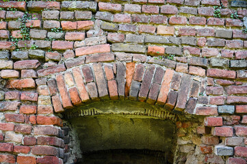 window opening in the ancient brick wall of the fortress