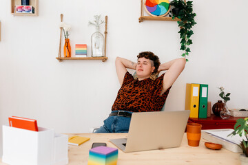 Calm non binary person resting at workplace