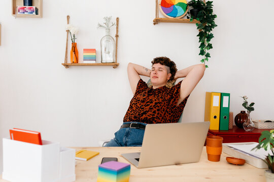 Calm non binary person resting at workplace