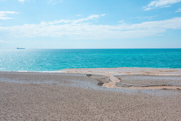 Drain of urban polluted river in the sandy beach sea coast. Ecological problem.