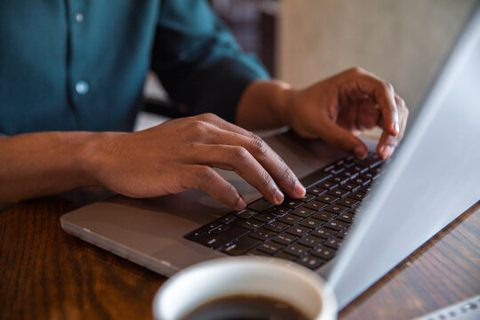 Black entrepreneur typing on laptop