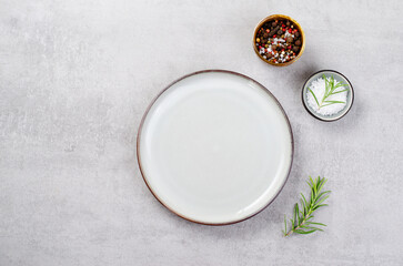 Empty Plate, Salt and Pepper on Grey Concrete Background, Top View
