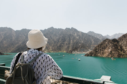 A woman looking at Hatta lake in UAE.