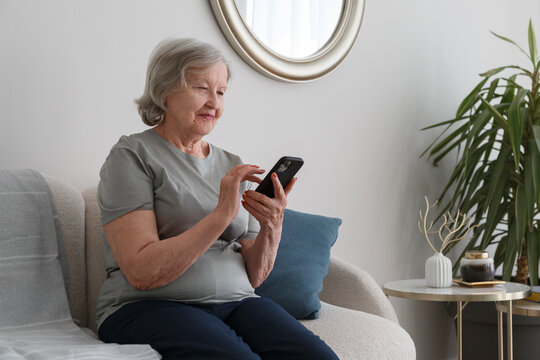 Elderly woman video calling on smartphone