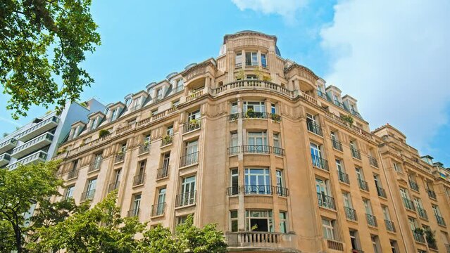 Cinematic view of French buildings in Paris. Historical old landmarks of Paris, architectural buildings. Typical Parisian building with balconies and windows in France.