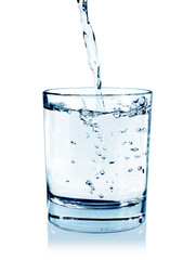 pouring water on a glass on white background