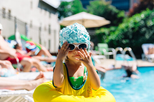 Cute portrait of toddler girl with swim cap and sunglasses
