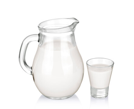 A glass of milk and a milk jug on white background.