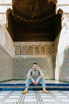 Tourist posing in front of a traditional moroccan building